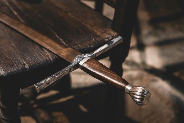 Close-up of a dagger-like knife sheathed under a wooden table emphasizing daily devotion themes.
