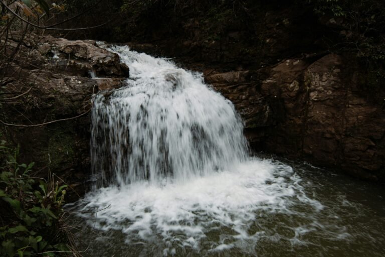 Waterfall cascading over rocks in a forest stream for Renewable Source of Life.